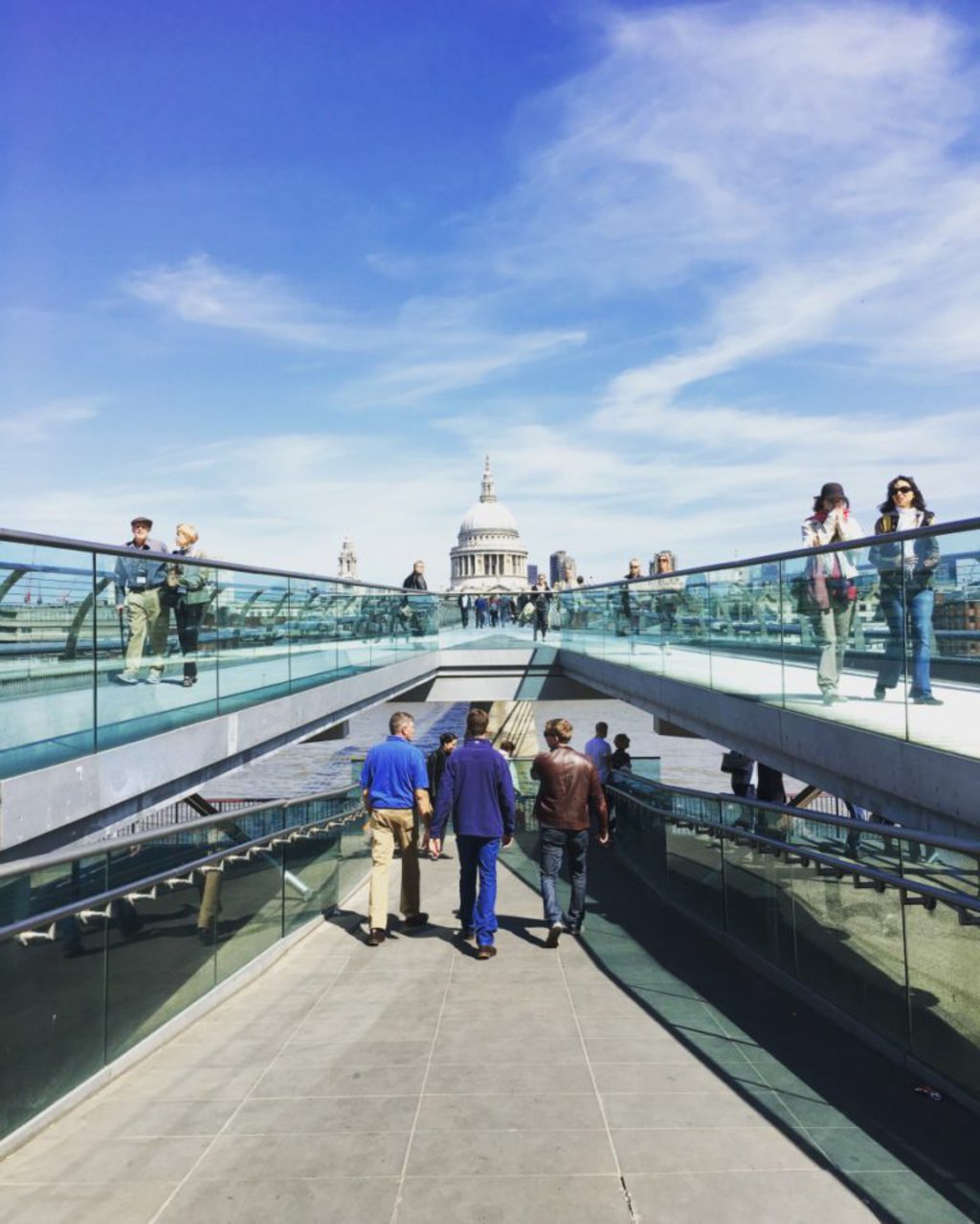 people walking on a bridge 