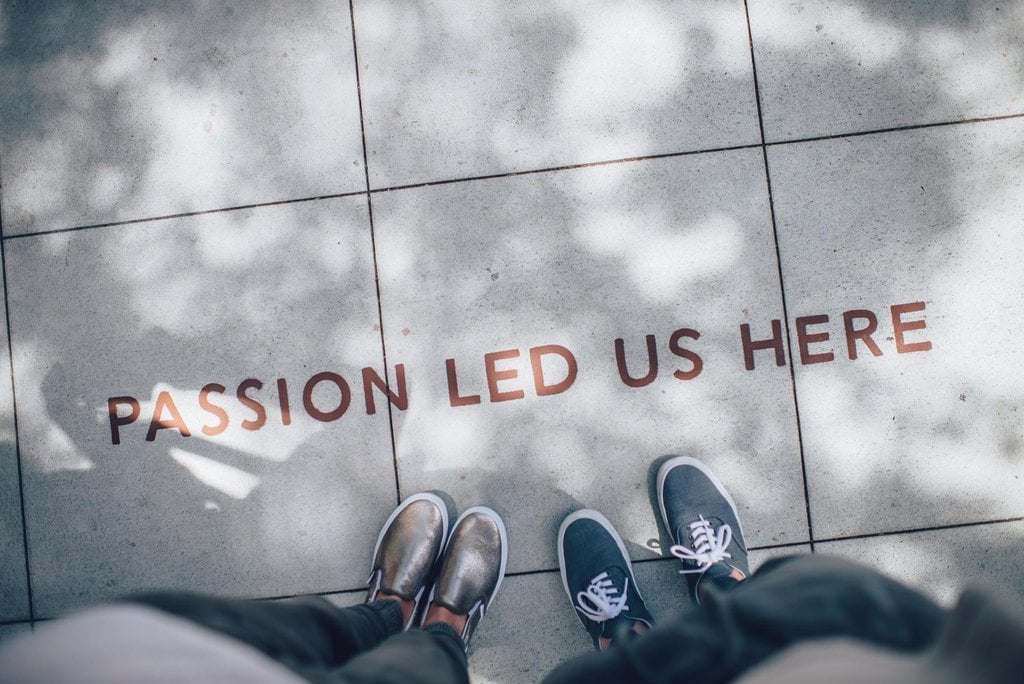 Looking down at the work 'passion led us here' written on the ground. 