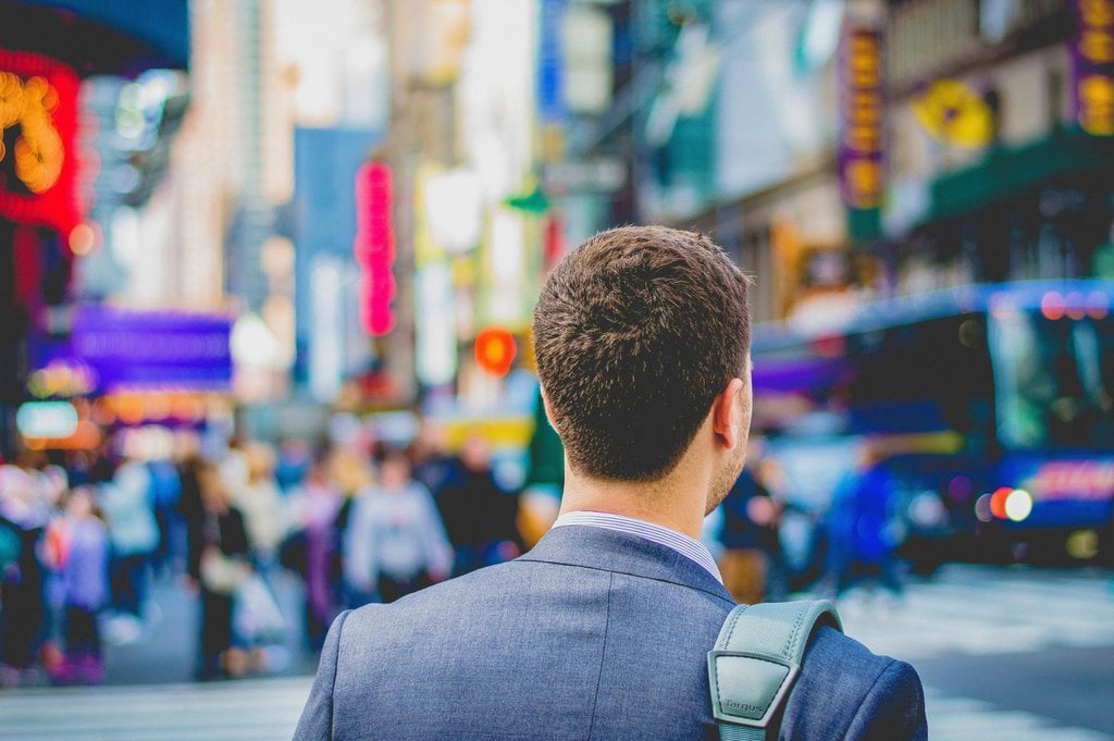 Man looking over a city at ground level 