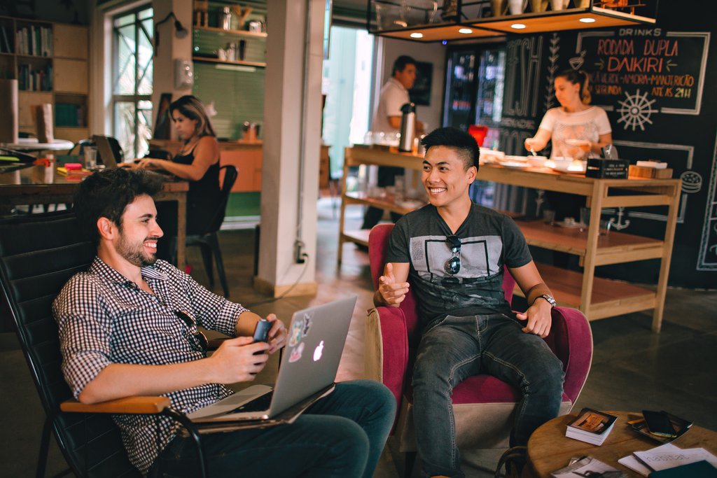 2 people sitting down and working a laptop 